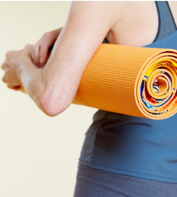 Woman holding yoga mat